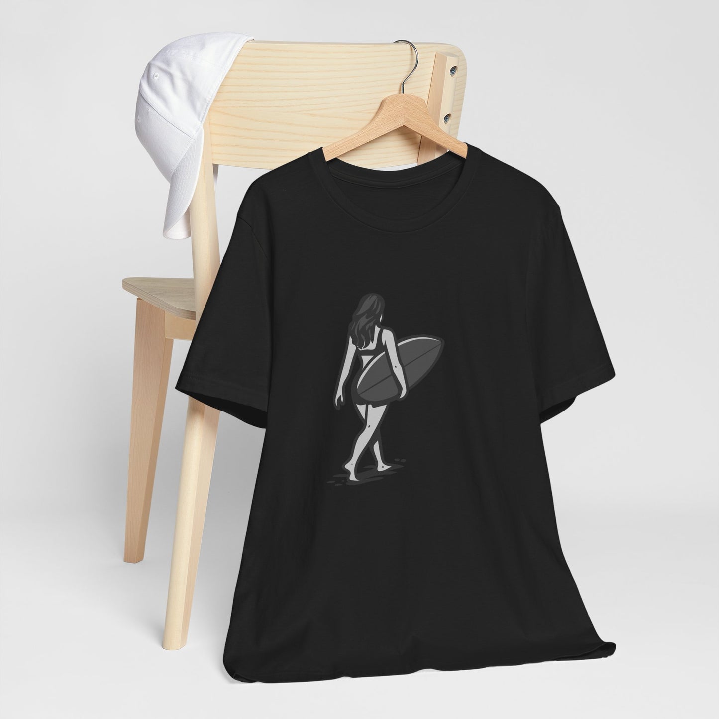 Surfer Girl Walking Graphic T-Shirt – Dark Theme Grayscale Beach Scene on Black Tee with Coastal Calm and Modern Ghost Effect. Unisex Jersey Short Sleeve Tee