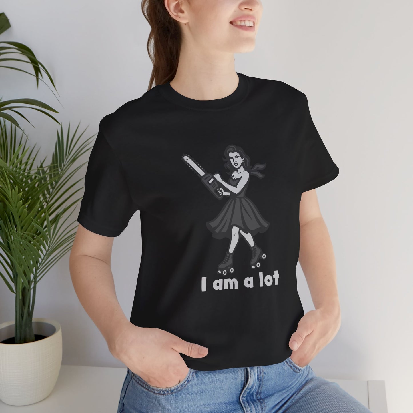 I Am a Lot Shirt – Fierce Skater Girl with Chainsaw in Dark Theme Retro Cartoon Style. Unisex Jersey Short Sleeve Tee